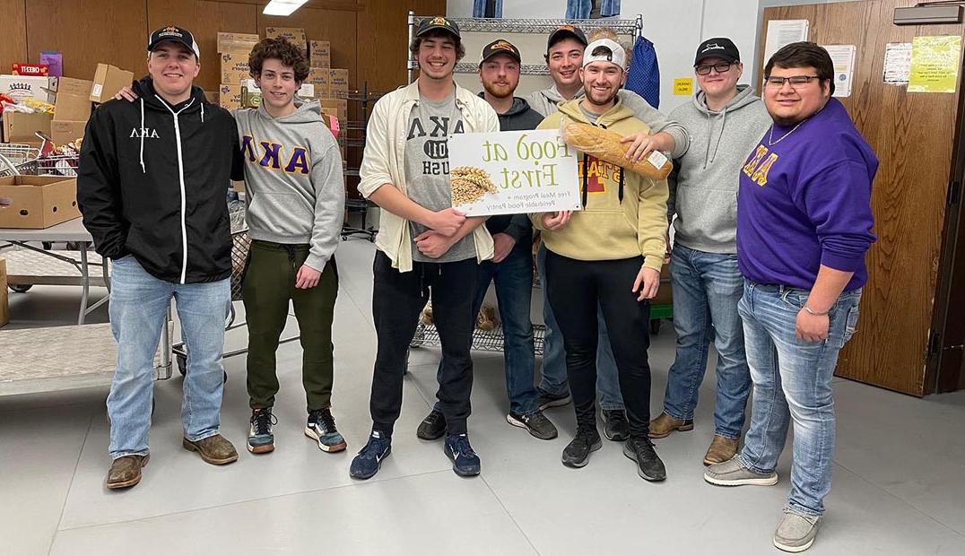 A group of fraternity members pose at their Food at First volunteer shift.